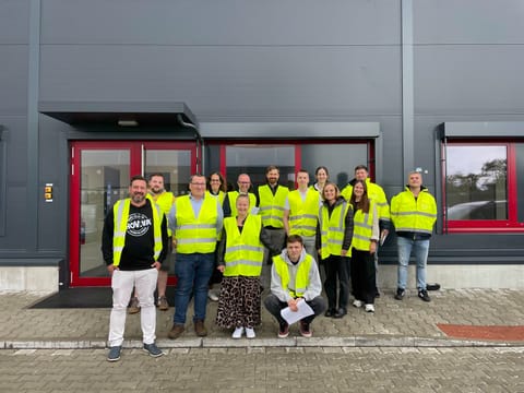 The Pilsen team in high-visibility vests outside the production site