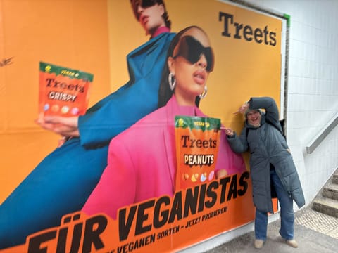 A colleague next to a Treets billboard
