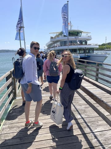 The team on a lakeside pier on a sunny day